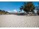 Expansive beach view, showing patrons, chairs, and tables under beach umbrellas at 715 Fontana Ln, Bradenton, FL 34209