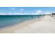 Beautiful white sand beach with people enjoying the water and weather at 715 Fontana Ln, Bradenton, FL 34209
