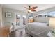 Inviting bedroom with French doors to a patio, hardwood floors, and a stylish ceiling fan at 715 Fontana Ln, Bradenton, FL 34209