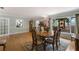 Inviting dining room featuring hardwood floors, decorative window, and a classic grandfather clock at 715 Fontana Ln, Bradenton, FL 34209
