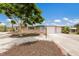 Charming single-story home with manicured front yard, shade tree, and driveway leading to a two-car garage at 715 Fontana Ln, Bradenton, FL 34209