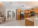 Spacious kitchen with stainless steel appliances, light wood cabinets and white tile floors at 715 Fontana Ln, Bradenton, FL 34209