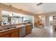 Well-lit kitchen with stainless steel dishwasher, natural light, and tiled flooring at 715 Fontana Ln, Bradenton, FL 34209
