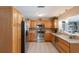 Functional kitchen with stainless appliances and light wood cabinets, offering ample counter space at 715 Fontana Ln, Bradenton, FL 34209