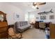 Comfortable living room with a gray sofa, desk, and eclectic decor, perfect for relaxation and productivity at 715 Fontana Ln, Bradenton, FL 34209