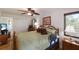 Comfortable main bedroom with wood furnishings, ceiling fan, and ample natural light at 715 Fontana Ln, Bradenton, FL 34209