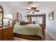 Cozy main bedroom with hardwood floors, ceiling fan, and warm lighting at 715 Fontana Ln, Bradenton, FL 34209