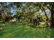 Park area with green grass, mature trees, benches, and playground equipment providing a tranquil outdoor space at 715 Fontana Ln, Bradenton, FL 34209
