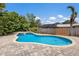 Sparkling pool with lush landscaping and a spa, creating a private and serene backyard retreat at 715 Fontana Ln, Bradenton, FL 34209