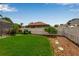 Well-maintained backyard featuring lush green grass, mulch, and a white picket fence at 730 Old Quarry Rd, Bradenton, FL 34212
