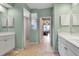 Bathroom showcasing a walk-in shower, dual sink vanity, and light green walls at 730 Old Quarry Rd, Bradenton, FL 34212