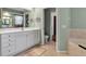 Bathroom displaying a soaking tub, dual sink vanity, and neutral colored tiles at 730 Old Quarry Rd, Bradenton, FL 34212