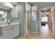 Bathroom showcasing a walk-in shower, dual sink vanity, and light green walls at 730 Old Quarry Rd, Bradenton, FL 34212