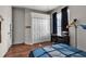 Bright bedroom boasts hardwood floors, a spacious closet, a desk, and ample natural light at 730 Old Quarry Rd, Bradenton, FL 34212