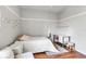 Cozy bedroom featuring wood floors, a white bedspread, a desk, and decor at 730 Old Quarry Rd, Bradenton, FL 34212