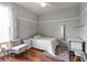 Bright bedroom with hardwood floors, a comfortable chair, ample closet space, and a cozy ambiance at 730 Old Quarry Rd, Bradenton, FL 34212