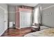 Inviting bedroom featuring hardwood floors, a spacious closet, a cozy chair, and ample natural light at 730 Old Quarry Rd, Bradenton, FL 34212