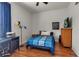 Comfortable bedroom featuring hardwood floors, a ceiling fan, a desk, and ample natural light at 730 Old Quarry Rd, Bradenton, FL 34212