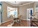 Dining area with hardwood floors, a round table, and views of the pool area through a large window at 730 Old Quarry Rd, Bradenton, FL 34212
