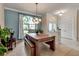 Spacious dining area featuring tile floors, contemporary lighting, and a large picture window at 730 Old Quarry Rd, Bradenton, FL 34212