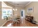 Bright dining room with wood floors, chandelier, and pool view through large window at 730 Old Quarry Rd, Bradenton, FL 34212
