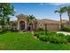 Charming single-story home featuring lush landscaping, a barrel tile roof, and an attached two-car garage at 730 Old Quarry Rd, Bradenton, FL 34212