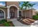 Inviting front entryway with arched windows, stately columns, and a meticulously maintained garden at 730 Old Quarry Rd, Bradenton, FL 34212