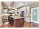Modern kitchen with white cabinets, stainless steel appliances, and a large island with seating at 730 Old Quarry Rd, Bradenton, FL 34212