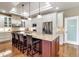 Bright kitchen features stainless steel appliances, large island, granite counters, and modern pendant lighting at 730 Old Quarry Rd, Bradenton, FL 34212