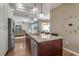 Modern kitchen with stainless steel appliances, island with seating, and open layout to the living area at 730 Old Quarry Rd, Bradenton, FL 34212