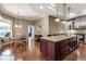Spacious kitchen boasts a large island with granite countertops and wood flooring, adjacent to the dining area at 730 Old Quarry Rd, Bradenton, FL 34212