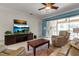 Cozy living room featuring tile floors, a modern entertainment center, and access to the lanai at 730 Old Quarry Rd, Bradenton, FL 34212