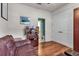 Bright living area includes a comfortable leather sofa, TV, and direct access to the en-suite bathroom at 730 Old Quarry Rd, Bradenton, FL 34212