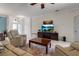 Living room showcasing tile floors, comfortable seating, and entertainment center at 730 Old Quarry Rd, Bradenton, FL 34212