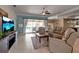 Open living room featuring tile flooring, plush leather seating, and seamless access to the pool area at 730 Old Quarry Rd, Bradenton, FL 34212