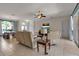 Bright and airy living room with tile floors, stylish furniture, and access to outdoor spaces at 730 Old Quarry Rd, Bradenton, FL 34212