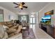 Spacious living room with tile floors, comfortable leather seating, and a large television at 730 Old Quarry Rd, Bradenton, FL 34212