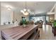 Open-concept living room featuring tile flooring, a modern chandelier and sliding doors to the lanai at 730 Old Quarry Rd, Bradenton, FL 34212
