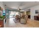 Spacious living room with tile flooring, comfortable leather seating, and access to the pool area at 730 Old Quarry Rd, Bradenton, FL 34212