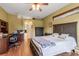 Spacious main bedroom boasts a ceiling fan, wood floors, and adjoining office space at 730 Old Quarry Rd, Bradenton, FL 34212