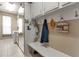 Mud room includes cabinets, hooks, bench, mirror and access to laundry area at 730 Old Quarry Rd, Bradenton, FL 34212