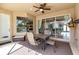 Outdoor patio with ceiling fan, table and chairs, view of the pool and a TV at 730 Old Quarry Rd, Bradenton, FL 34212