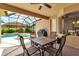 Outdoor patio with a table and chairs, ceiling fan and a black grill at 730 Old Quarry Rd, Bradenton, FL 34212