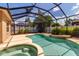 Screened in pool and spa area surrounded by lush landscaping and a black frame at 730 Old Quarry Rd, Bradenton, FL 34212