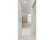 Hallway view to a bright bathroom with a glass shower and soaking tub at 7327 38Th Court East, Sarasota, FL 34243