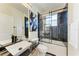 Modern bathroom features a vessel sink, black marble tile shower and unique abstract art at 7327 38Th Court East, Sarasota, FL 34243