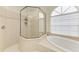 Bright bathroom features a glass shower, soaking tub, and tile surround at 7327 38Th Court East, Sarasota, FL 34243
