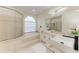 Well-lit bathroom features a soaking tub, glass shower, and dual sinks with granite counters at 7327 38Th Court East, Sarasota, FL 34243