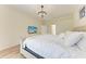 Spacious bedroom with a large bed, wood floors, a modern light fixture, and neutral decor at 7327 38Th Court East, Sarasota, FL 34243