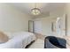 Bright bedroom features a decorative chandelier, light hardwood floors and a full-length mirror at 7327 38Th Court East, Sarasota, FL 34243